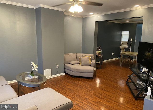 living room with dark wood-type flooring, crown molding, and ceiling fan