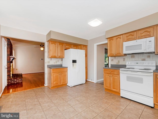 kitchen featuring decorative backsplash, ceiling fan, a brick fireplace, light hardwood / wood-style floors, and white appliances