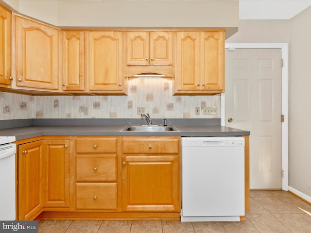 kitchen featuring light tile patterned floors, white dishwasher, and sink