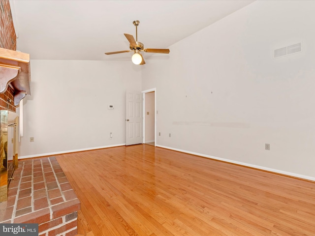 unfurnished living room with ceiling fan, hardwood / wood-style flooring, and high vaulted ceiling