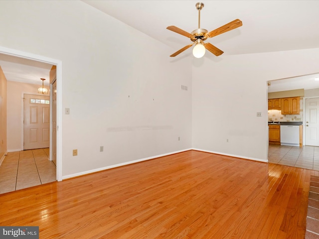 unfurnished living room featuring light hardwood / wood-style flooring, high vaulted ceiling, and ceiling fan