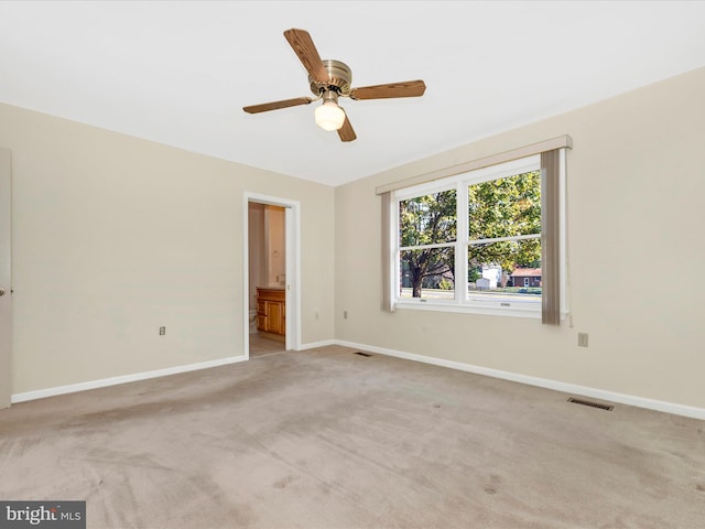 carpeted empty room with ceiling fan