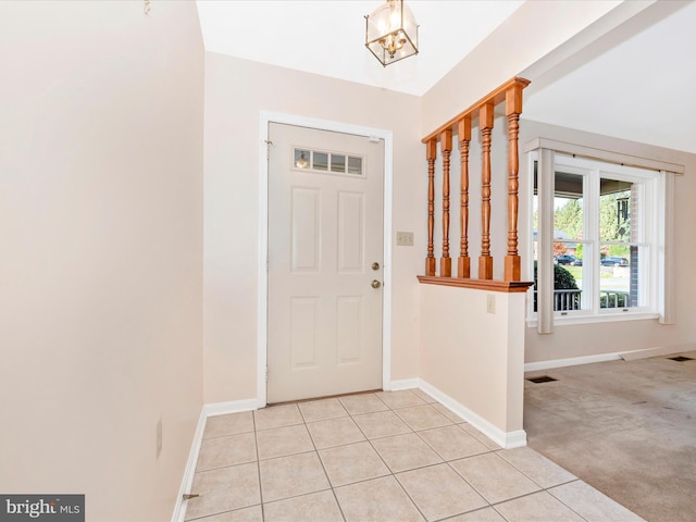 foyer featuring light carpet