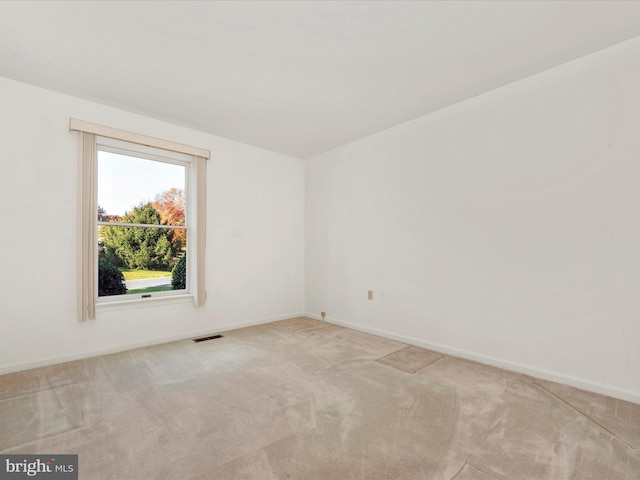 unfurnished room with light colored carpet