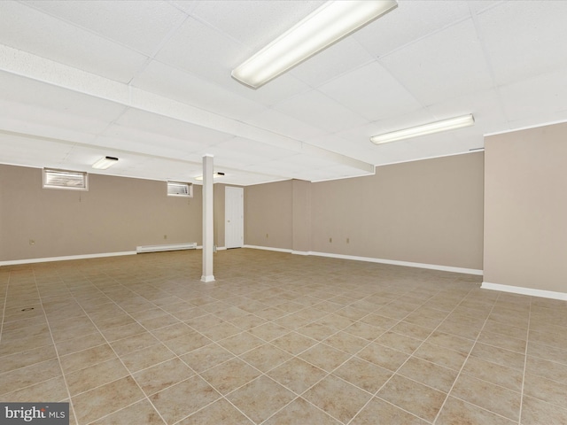 basement featuring baseboard heating and light tile patterned floors