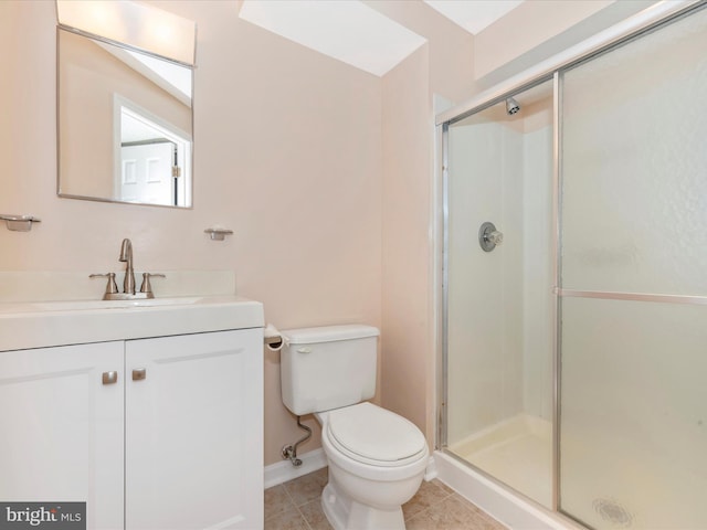 bathroom featuring vanity, toilet, tile patterned floors, and a shower with shower door