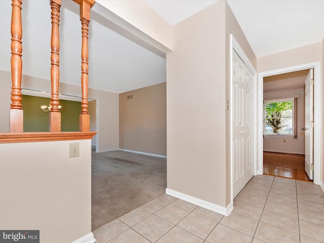 corridor with light colored carpet