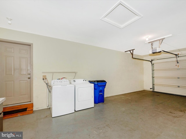 garage with a garage door opener and washer and clothes dryer