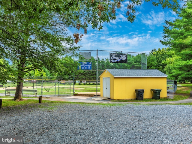 view of basketball court with a yard