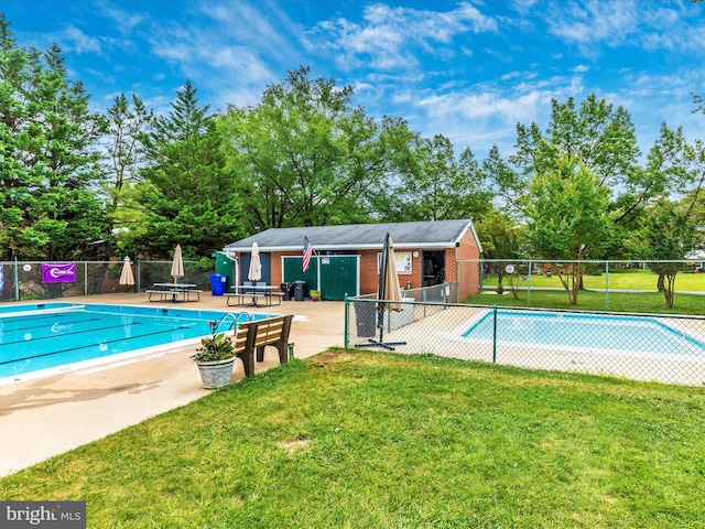 view of swimming pool with a yard and a patio