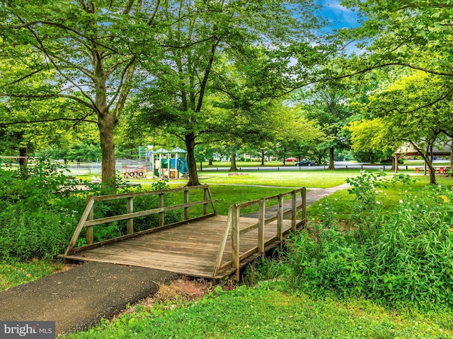 view of property's community with a lawn and a playground