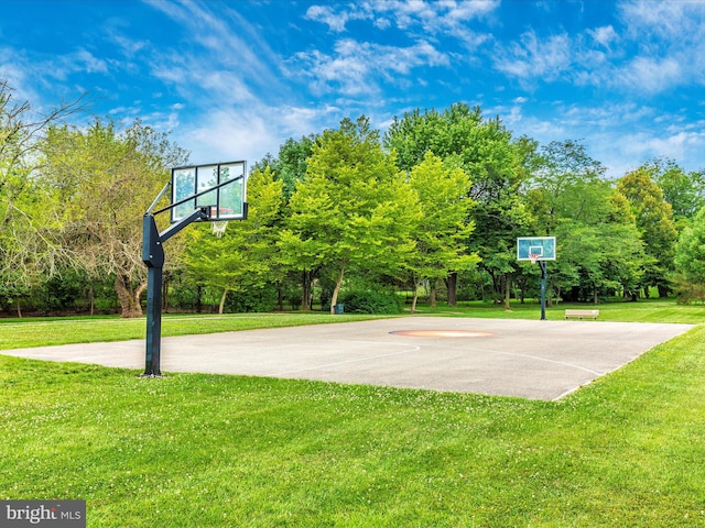 view of basketball court with a yard