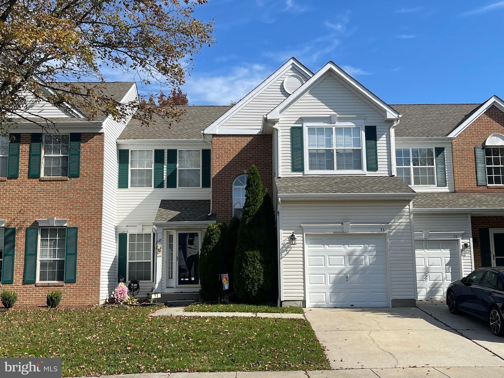 view of front of house with a front yard and a garage