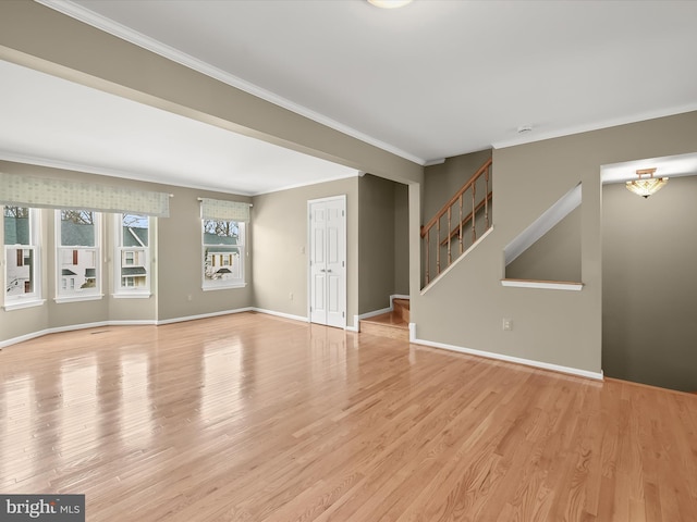 empty room featuring ornamental molding and light wood-type flooring