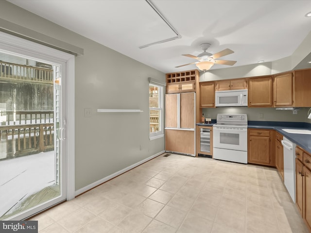 kitchen with sink, white appliances, wine cooler, and ceiling fan