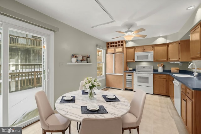 kitchen featuring ceiling fan, sink, white appliances, and beverage cooler