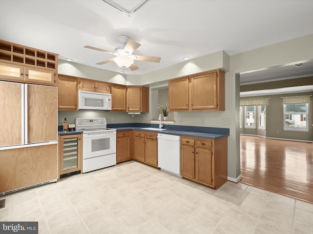 kitchen featuring sink, white appliances, ceiling fan, and beverage cooler