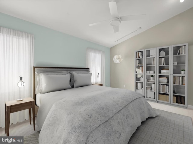 carpeted bedroom featuring ceiling fan, multiple windows, and lofted ceiling