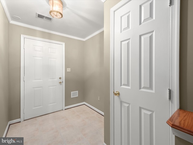 foyer entrance featuring light tile patterned floors and ornamental molding