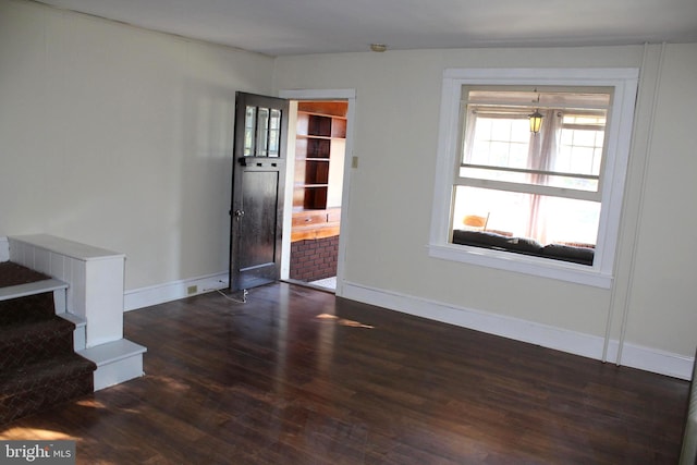 unfurnished room featuring dark hardwood / wood-style floors