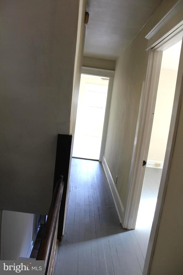 hallway with hardwood / wood-style flooring