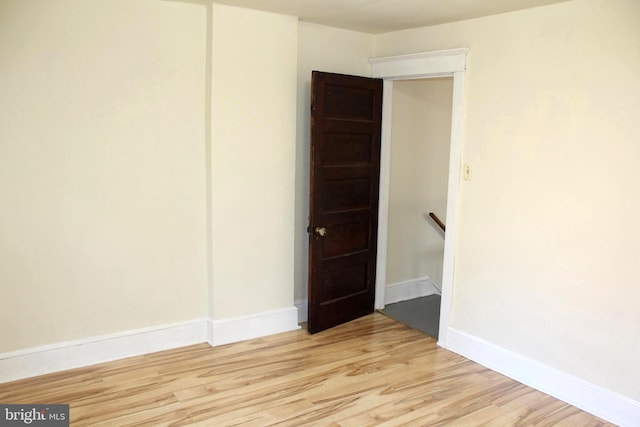 unfurnished room with light hardwood / wood-style floors