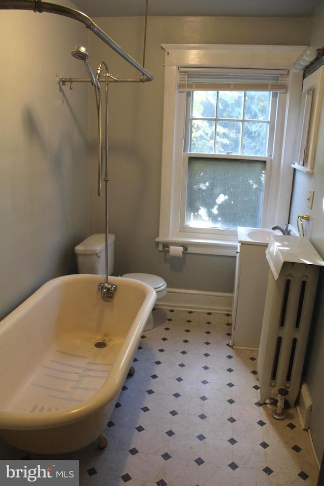 bathroom with radiator, toilet, plus walk in shower, and a notable chandelier