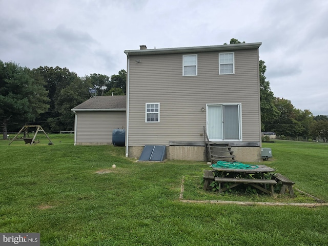 rear view of property with a lawn