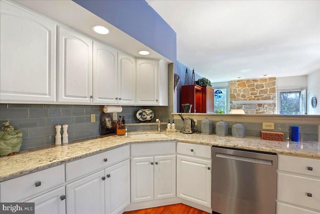 kitchen with white cabinets, stainless steel dishwasher, and sink