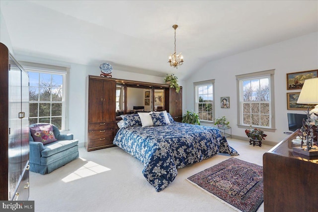 carpeted bedroom featuring an inviting chandelier and vaulted ceiling