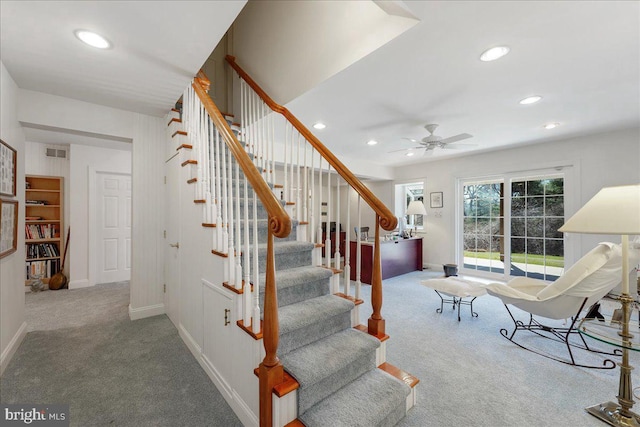 staircase featuring carpet and ceiling fan