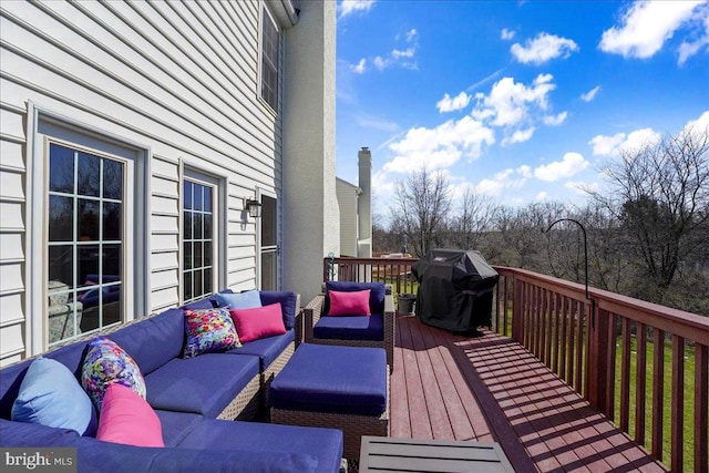 deck featuring grilling area and outdoor lounge area