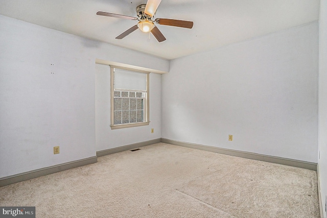 empty room with ceiling fan and carpet floors