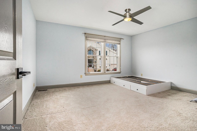 spare room featuring carpet flooring and ceiling fan