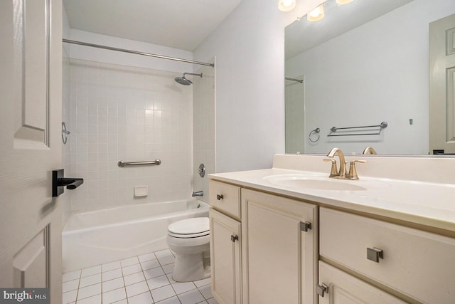 full bathroom with tile patterned flooring, tiled shower / bath combo, toilet, and vanity