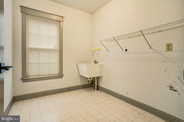 clothes washing area featuring sink and hookup for an electric dryer