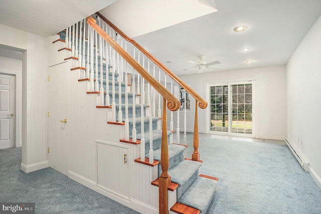 stairway featuring carpet floors, ceiling fan, and a baseboard heating unit