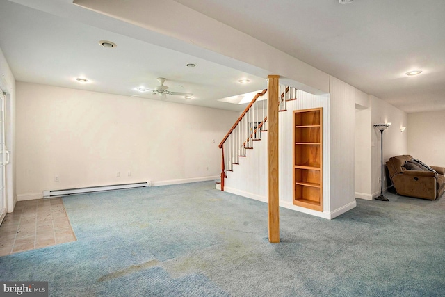 basement with carpet flooring, ceiling fan, and a baseboard radiator