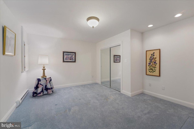 interior space with carpet and a baseboard radiator