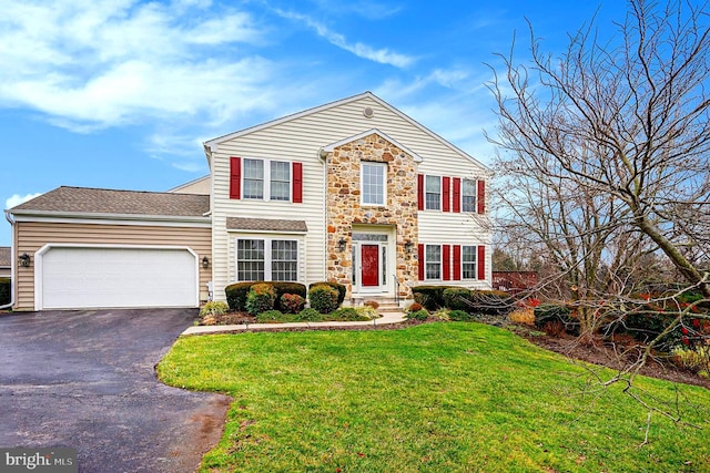 view of front of house with a front yard and a garage