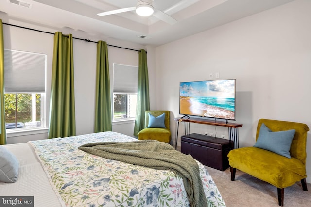 bedroom featuring carpet flooring, ceiling fan, and multiple windows