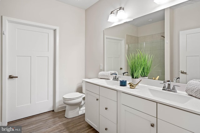 bathroom with vanity, hardwood / wood-style flooring, toilet, and an enclosed shower