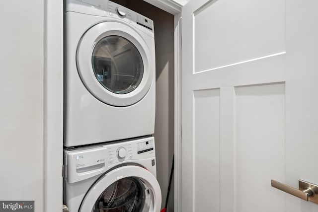 laundry room with stacked washing maching and dryer