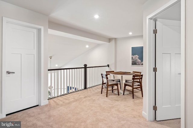 carpeted dining space featuring lofted ceiling with beams