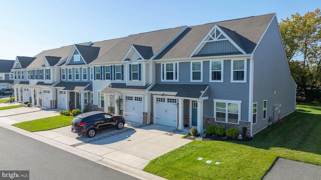 townhome / multi-family property with a front yard and a garage