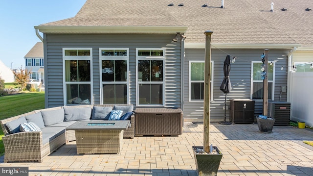 view of patio with cooling unit and an outdoor living space with a fire pit