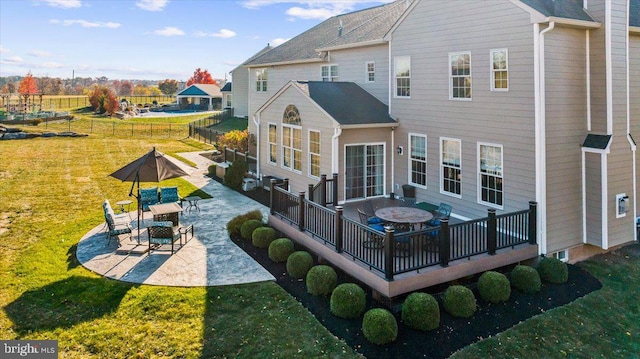 rear view of house featuring a patio area and a yard