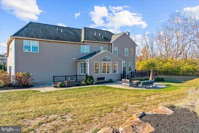 rear view of house with a yard and a patio