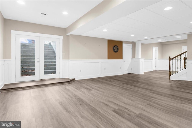 unfurnished living room with french doors and hardwood / wood-style flooring