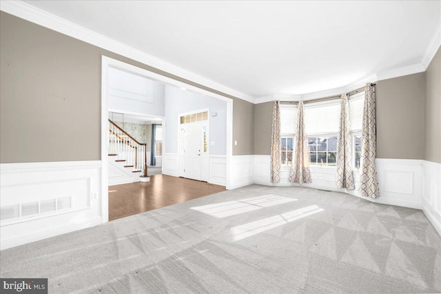 carpeted empty room featuring ornamental molding